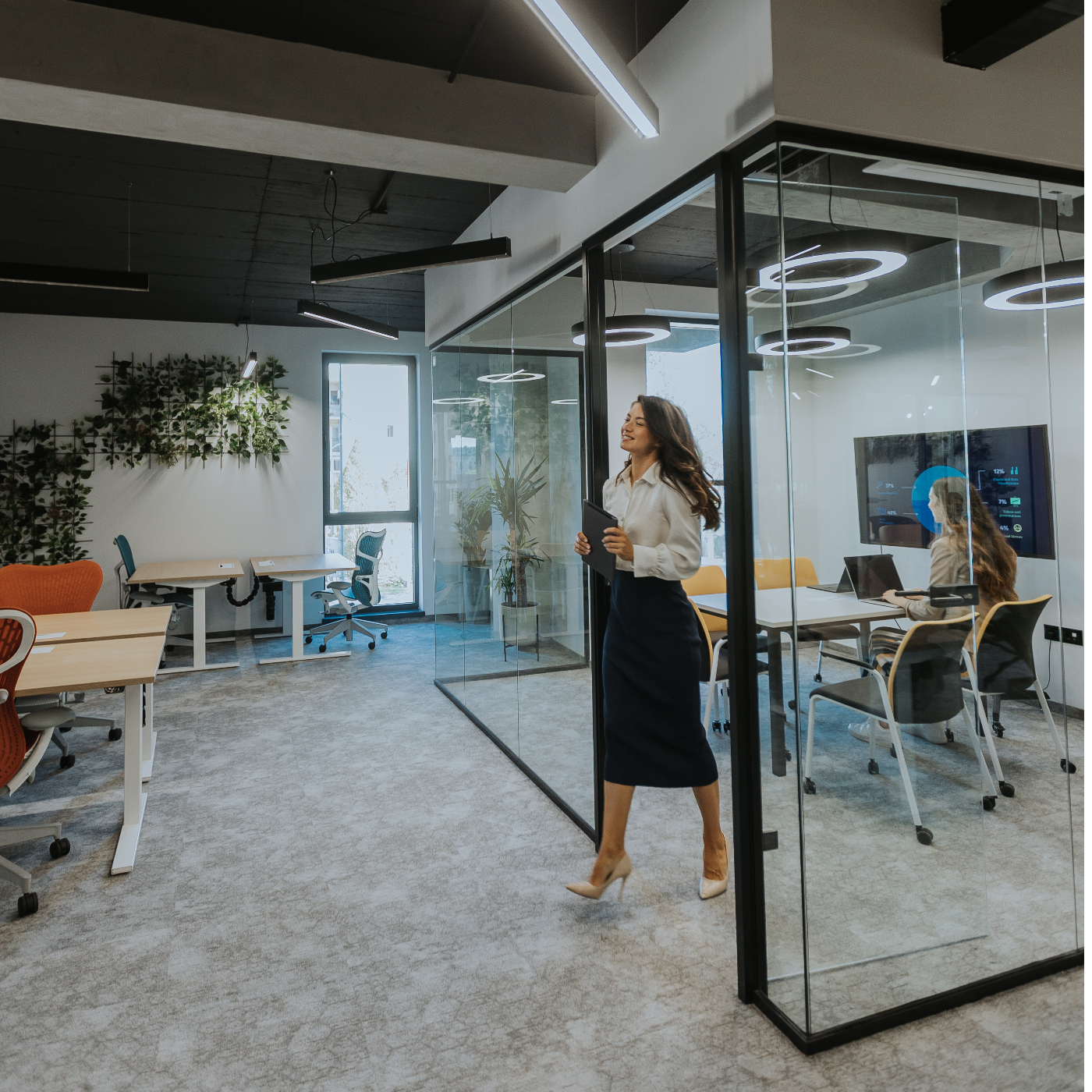 Woman walking is conference room in office.