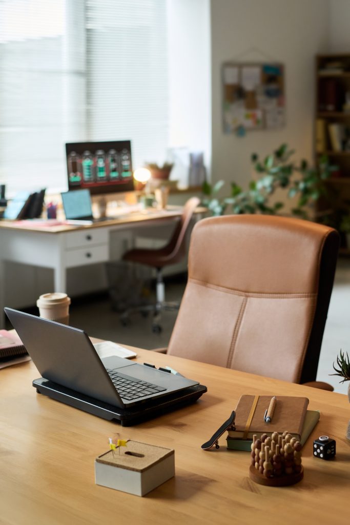 En empty desk at an office with leader chair.